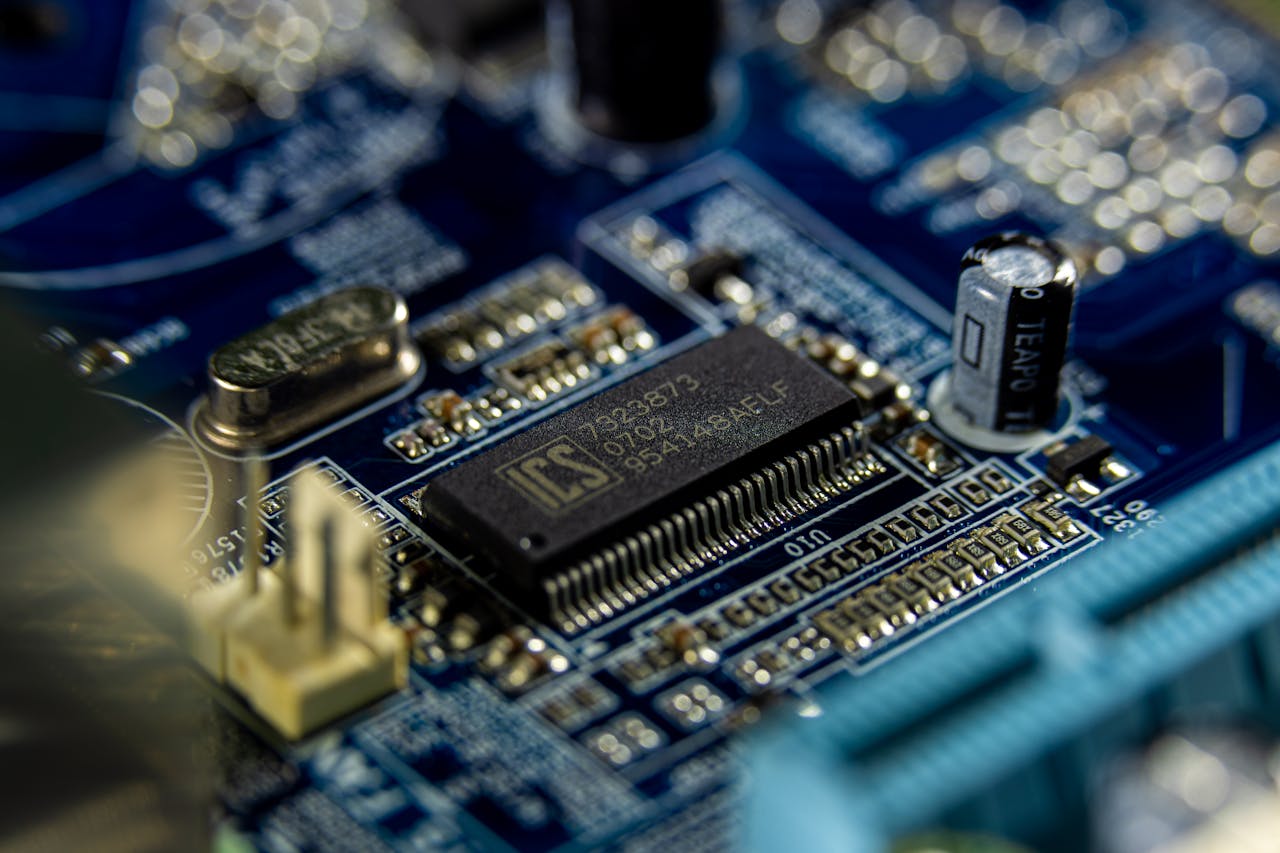 Detailed shot of a microprocessor on a blue motherboard showcasing electronic components.